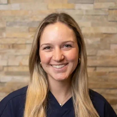 Anna, a Chiropractic Assistant, smiling at the camera