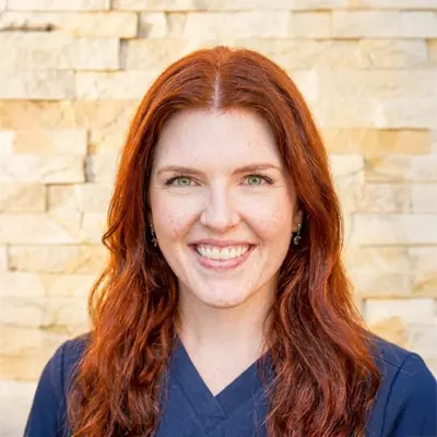 Torrie, a Front Office team member, smiling at the camera